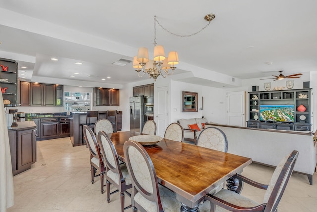 tiled dining area with ceiling fan with notable chandelier