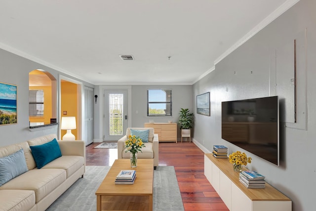 living room with hardwood / wood-style floors and ornamental molding