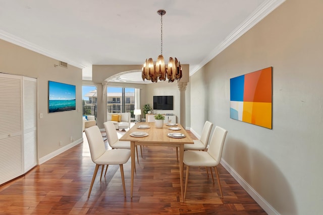 dining area featuring hardwood / wood-style flooring, a chandelier, and ornamental molding