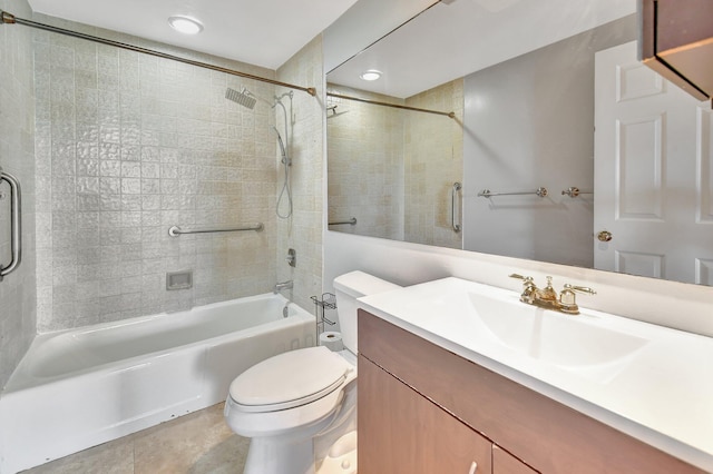 full bathroom featuring tile patterned flooring, toilet, vanity, and tiled shower / bath