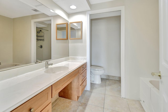 bathroom with tile patterned floors, vanity, toilet, and a bath