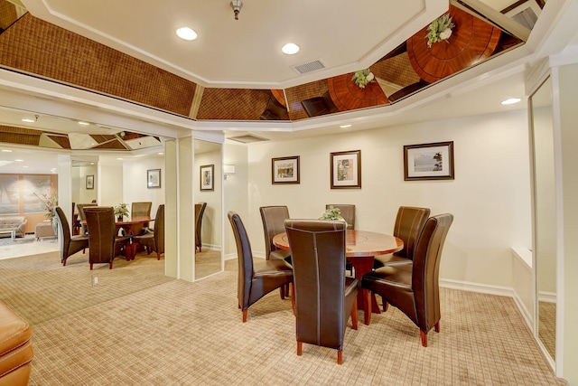 carpeted dining area featuring crown molding