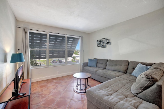 tiled living room featuring a textured ceiling