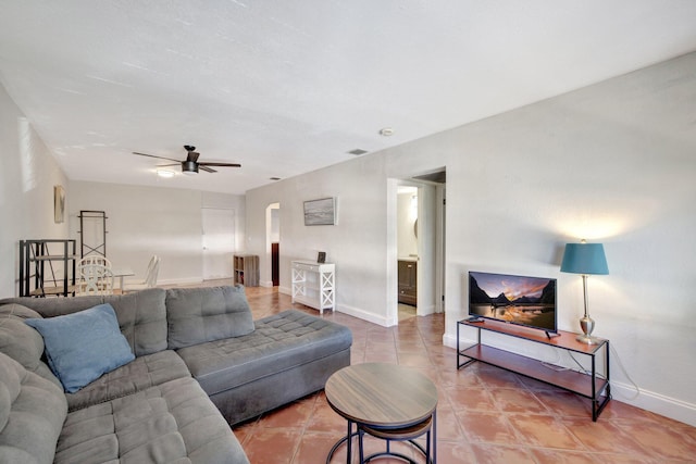 tiled living room with ceiling fan