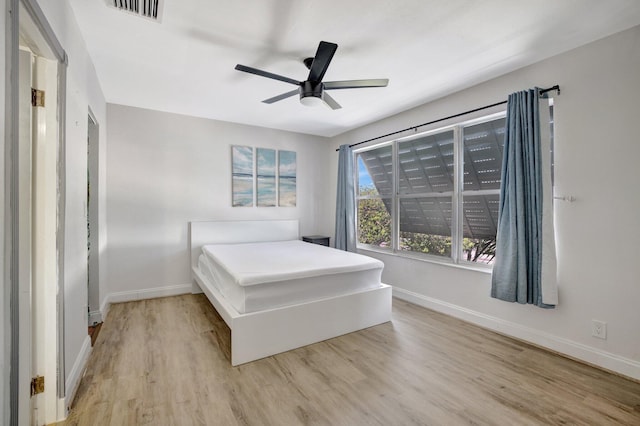 bedroom with ceiling fan and light hardwood / wood-style flooring