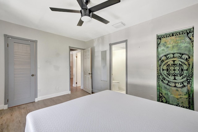 bedroom featuring ceiling fan, connected bathroom, and light hardwood / wood-style floors