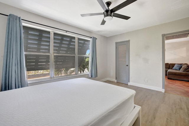 bedroom with hardwood / wood-style floors and ceiling fan