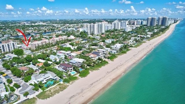 bird's eye view featuring a water view and a beach view