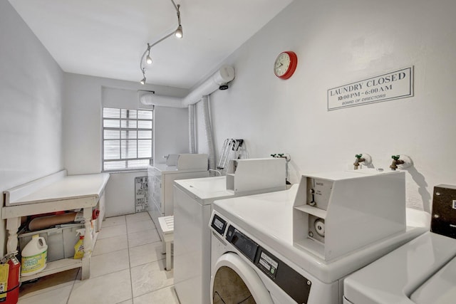 laundry room featuring light tile patterned flooring, track lighting, and separate washer and dryer