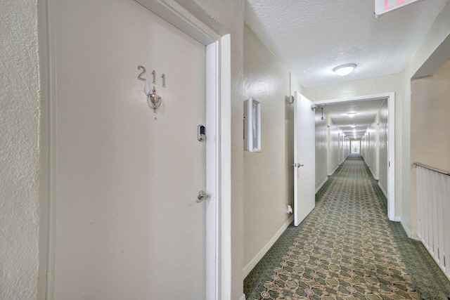 corridor featuring a textured ceiling