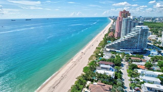 drone / aerial view with a water view and a view of the beach