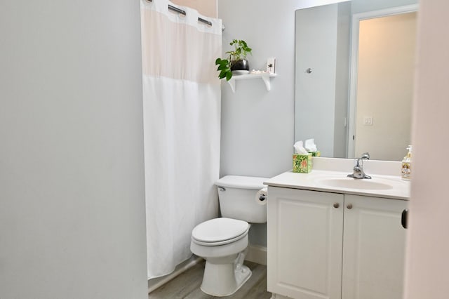 bathroom with walk in shower, vanity, toilet, and hardwood / wood-style flooring