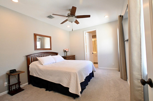 bedroom featuring ensuite bathroom, ceiling fan, and light colored carpet