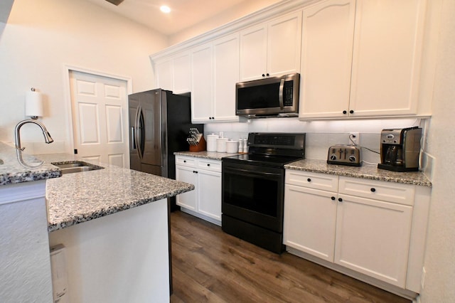 kitchen featuring light stone countertops, sink, stainless steel appliances, and white cabinets