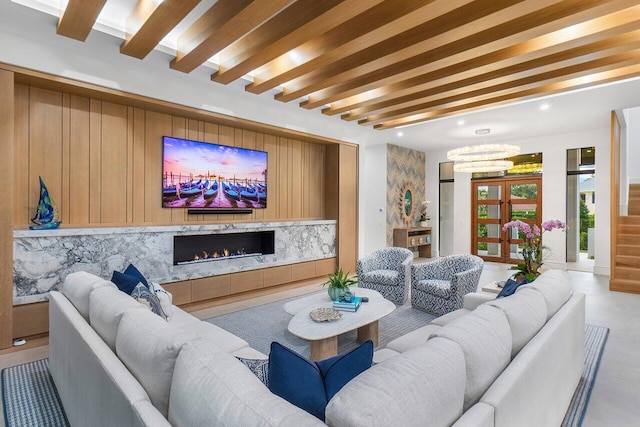 kitchen featuring appliances with stainless steel finishes, a raised ceiling, a large island, and decorative light fixtures