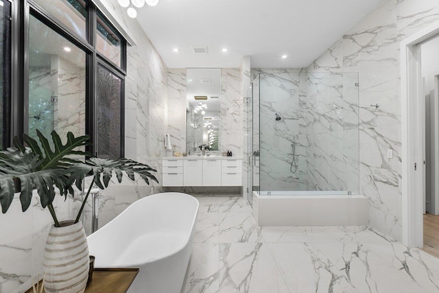 bathroom featuring vanity, tile walls, and a washtub