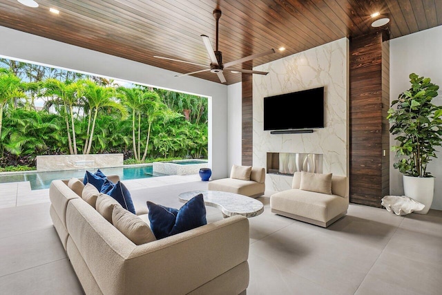 view of patio / terrace featuring area for grilling, ceiling fan, and exterior kitchen