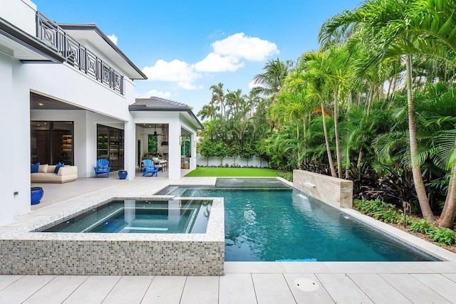 view of swimming pool with a lawn, an in ground hot tub, pool water feature, and a patio area