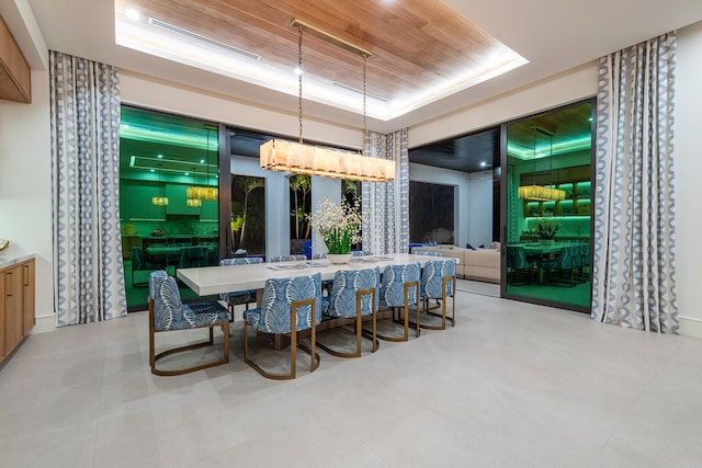 dining space featuring wood ceiling and a raised ceiling