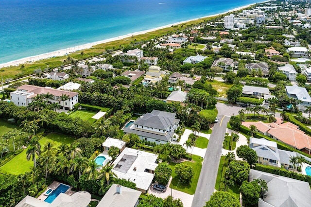 birds eye view of property featuring a view of the beach and a water view