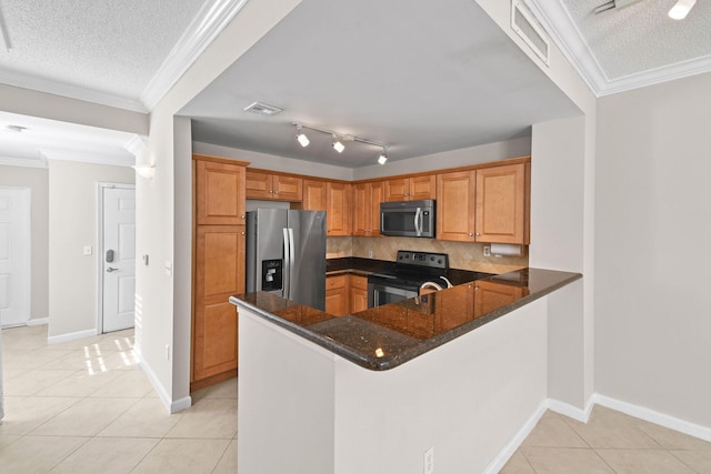 kitchen with kitchen peninsula, tasteful backsplash, stainless steel appliances, light tile patterned floors, and dark stone countertops