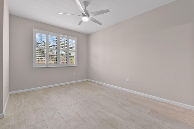 empty room with ceiling fan and light hardwood / wood-style floors