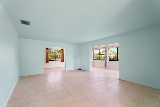 tiled spare room with plenty of natural light