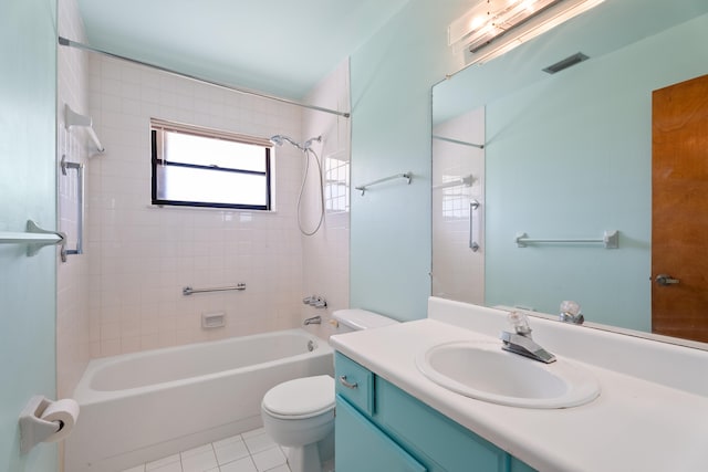 full bathroom with tiled shower / bath combo, vanity, toilet, and tile patterned floors