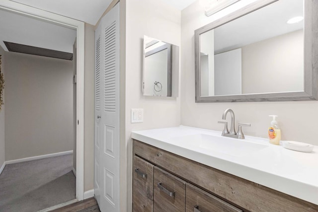 bathroom with hardwood / wood-style flooring and vanity