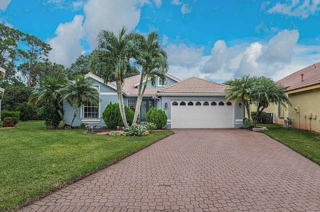 view of front of house featuring a front yard and a garage