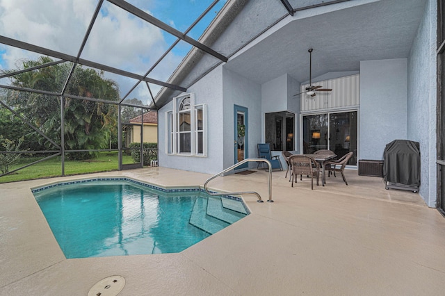 view of swimming pool with a lanai, ceiling fan, and a patio area