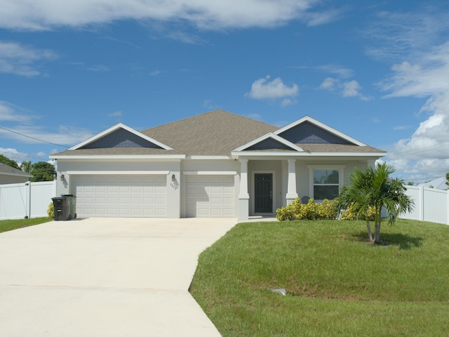 view of front of property featuring a garage and a front lawn