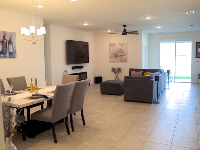 dining area featuring ceiling fan with notable chandelier and light tile patterned floors