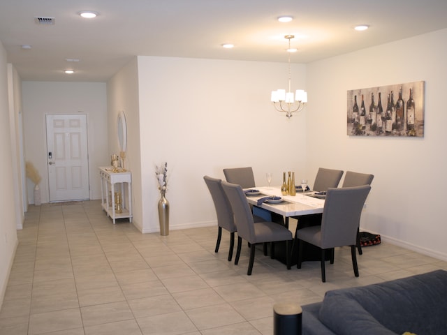 dining area featuring a notable chandelier and light tile patterned floors