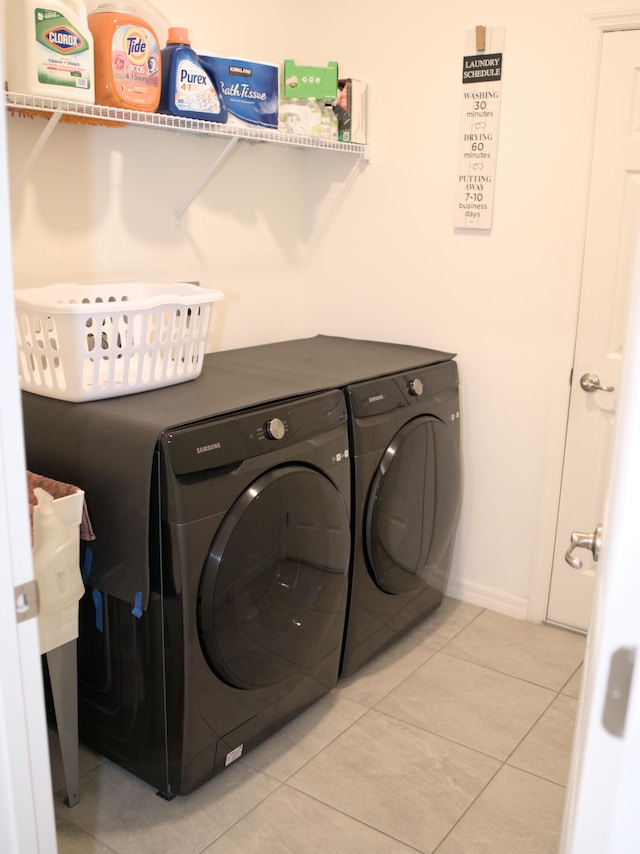 washroom featuring washer and clothes dryer and tile patterned flooring