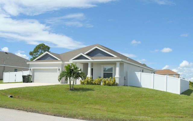 view of front of house with a front yard and a garage