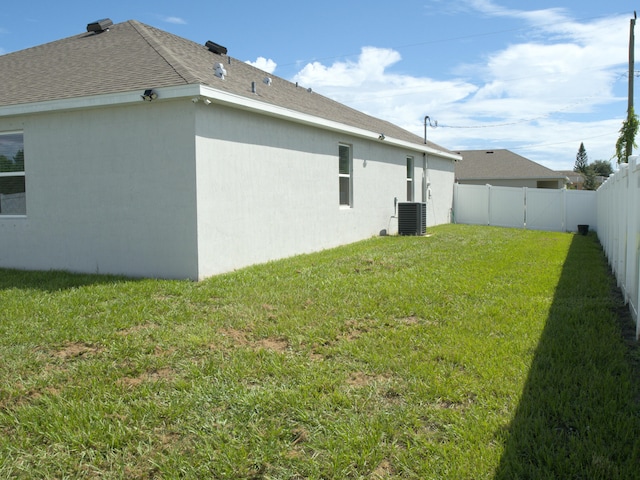 exterior space with a lawn and central air condition unit