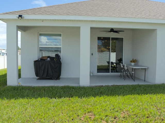 exterior space featuring a patio, ceiling fan, and a yard