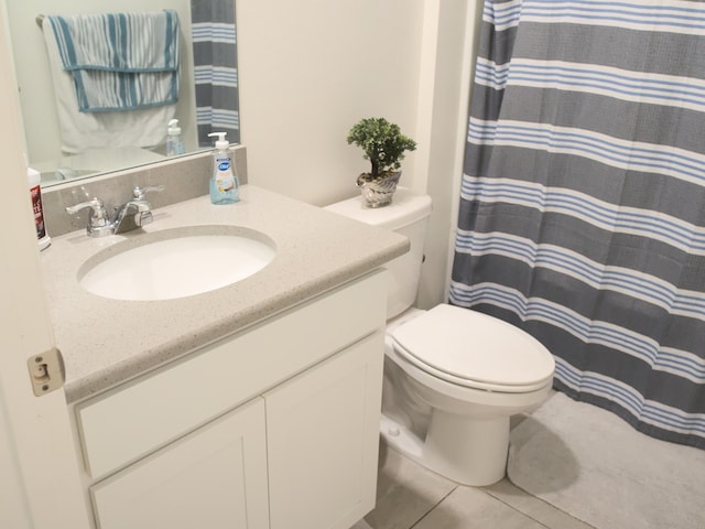 bathroom featuring vanity, toilet, and tile patterned floors