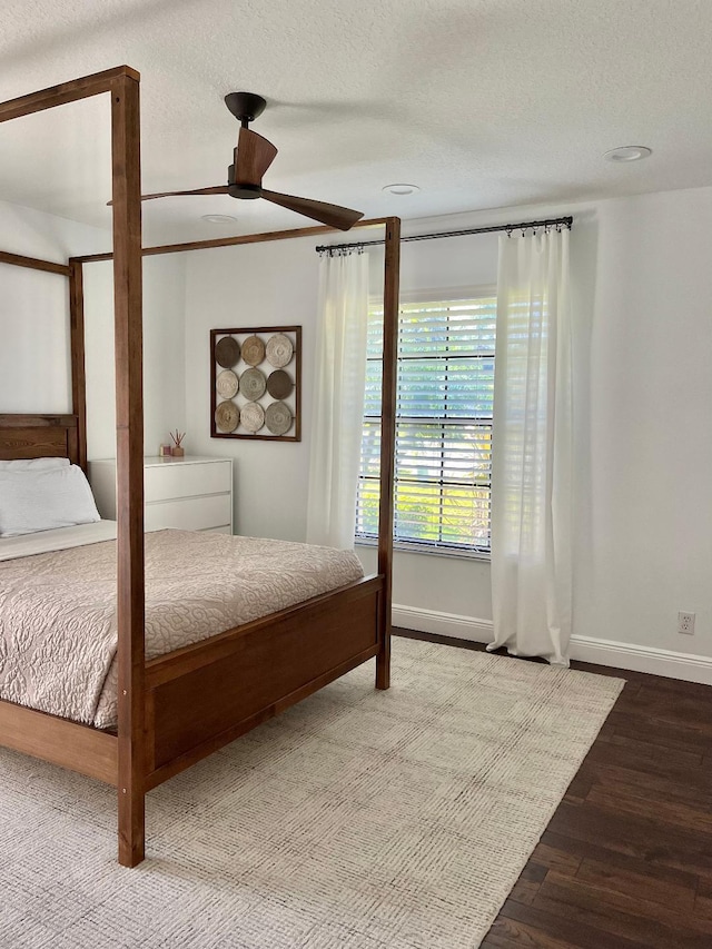 unfurnished bedroom with hardwood / wood-style flooring, ceiling fan, and a textured ceiling