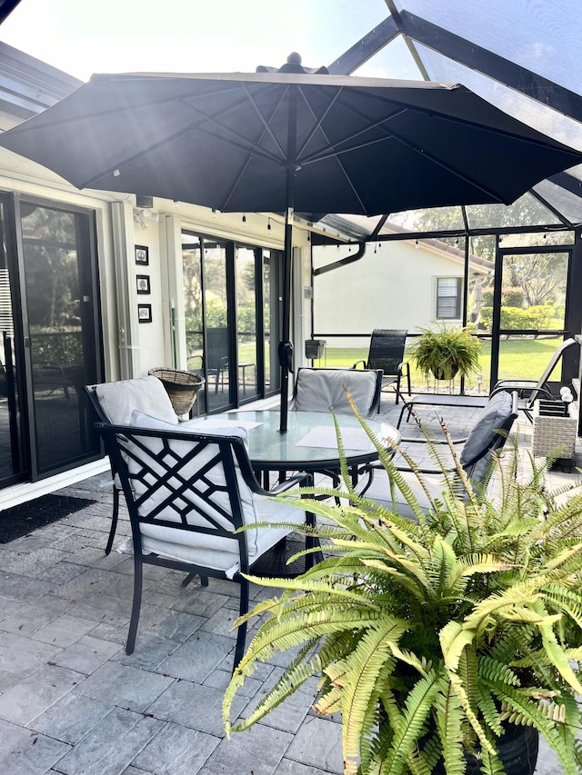 view of patio / terrace featuring glass enclosure