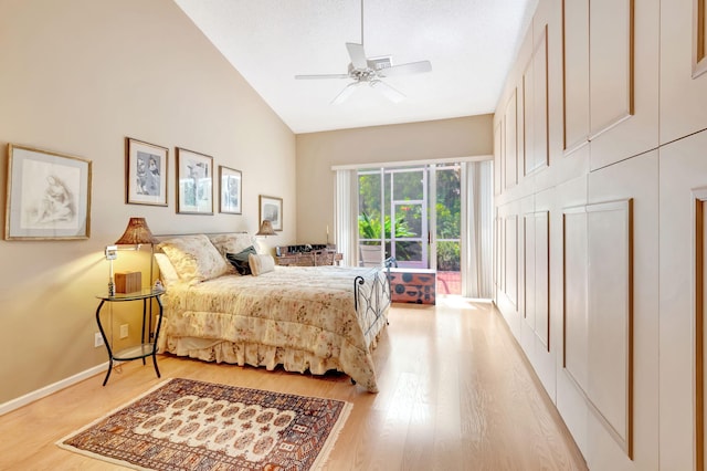 bedroom with light hardwood / wood-style flooring, ceiling fan, and high vaulted ceiling