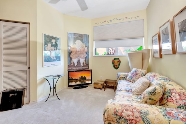 carpeted living room with ceiling fan