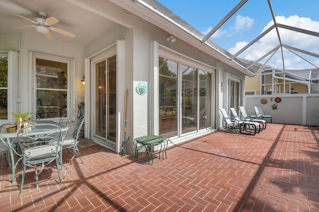 view of patio featuring a lanai and ceiling fan