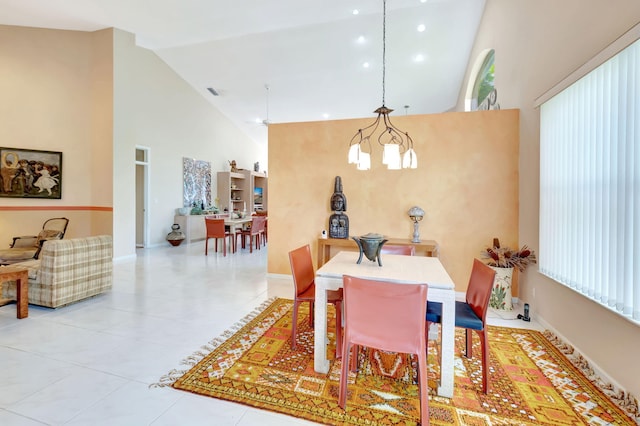 dining area with high vaulted ceiling, a notable chandelier, and light tile patterned floors