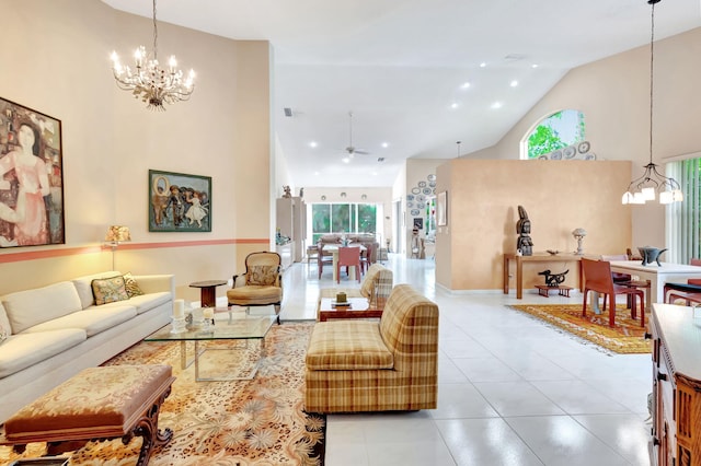 living room featuring ceiling fan with notable chandelier, light tile patterned floors, and high vaulted ceiling