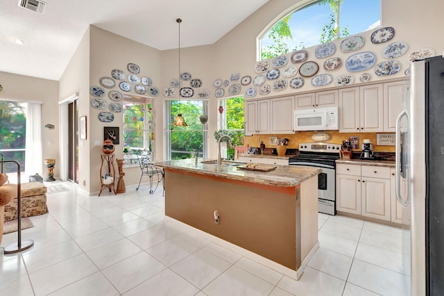 kitchen featuring sink, high vaulted ceiling, electric range, refrigerator with ice dispenser, and light stone countertops