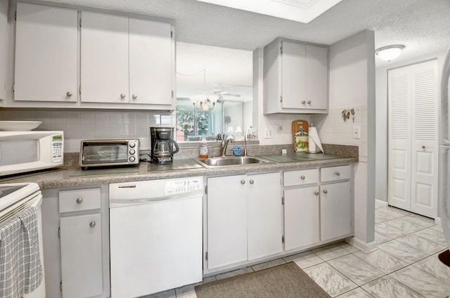 kitchen featuring decorative backsplash, sink, white appliances, and white cabinetry