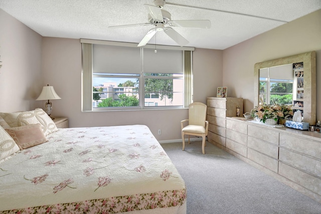 bedroom featuring multiple windows, a textured ceiling, carpet flooring, and ceiling fan