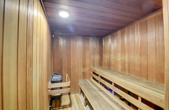 view of sauna / steam room featuring hardwood / wood-style flooring, wooden walls, and wood ceiling